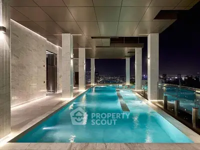 Luxurious rooftop pool with stunning city skyline views at night, perfect for upscale living.