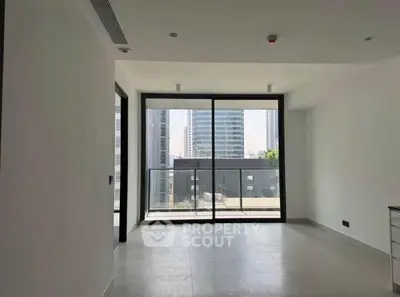 Spacious modern living room with large windows and city view, perfect for urban living.