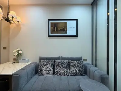 Cozy living room with elegant gray sofa and stylish wall art, perfect for relaxation.