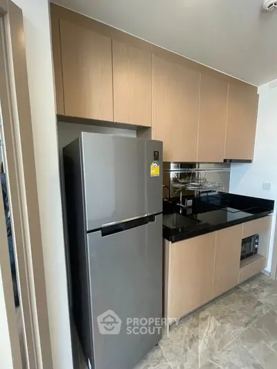 Modern kitchen with sleek cabinets and stainless steel fridge