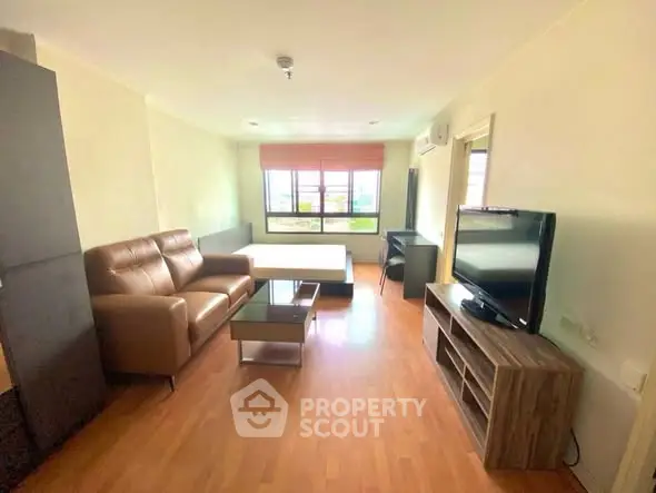 Spacious living room with modern furniture and large window view