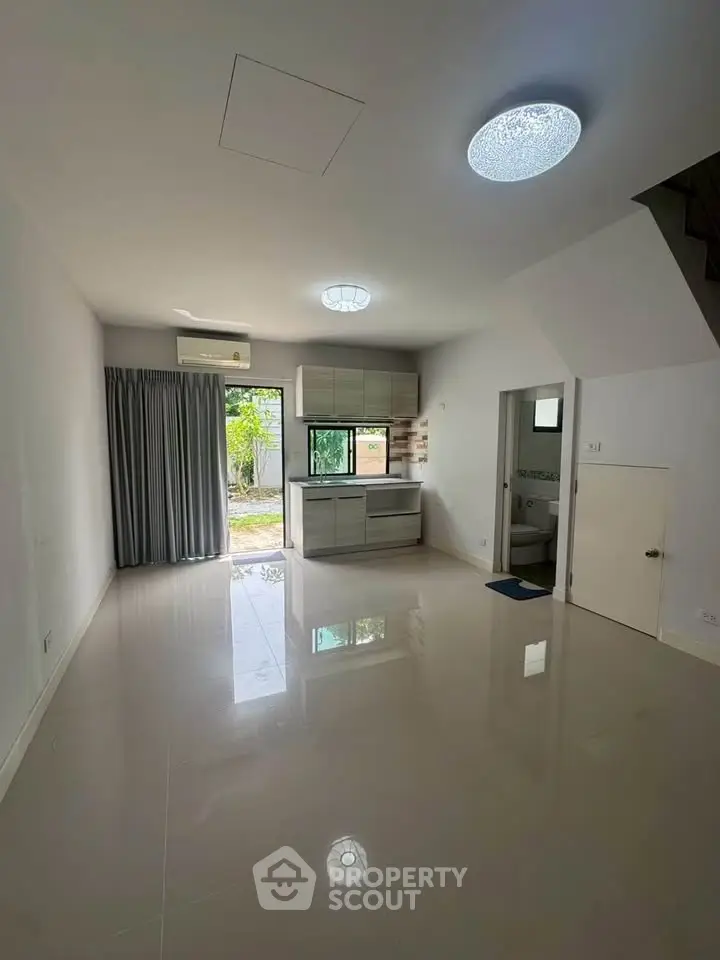 Spacious modern living room with open layout and large window view