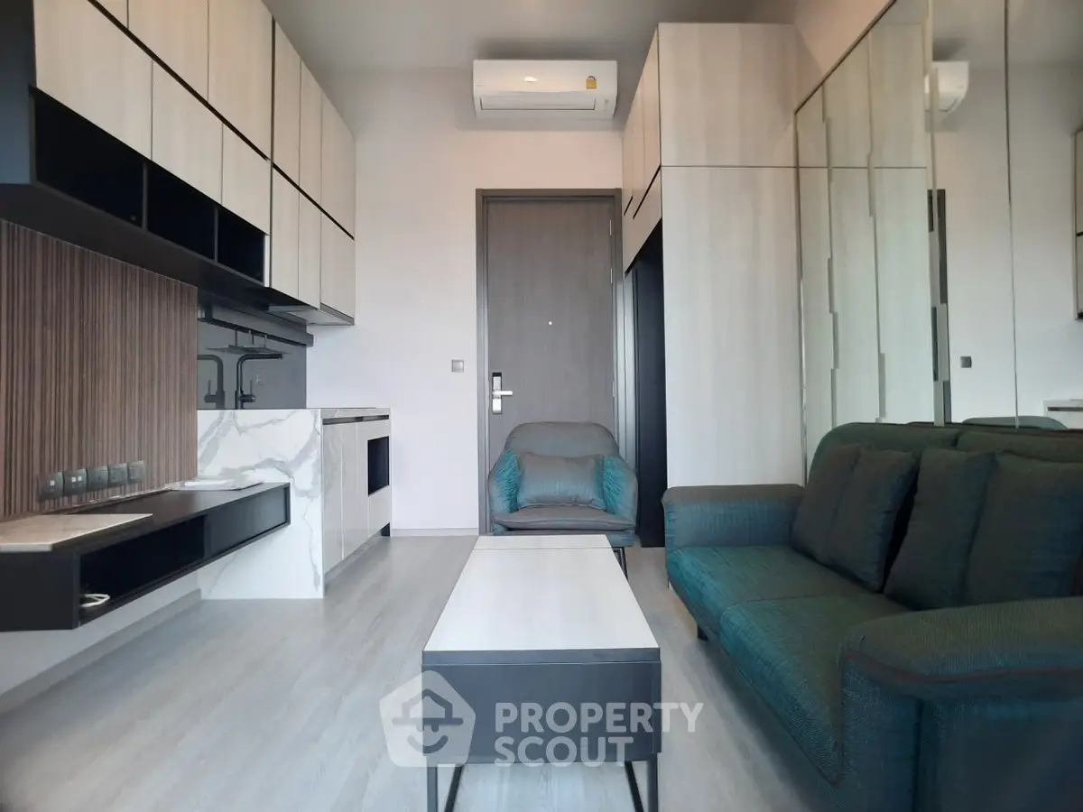 Modern living room with sleek furniture and minimalist design, featuring a comfortable sofa and stylish cabinetry.