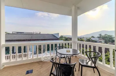 Charming balcony with scenic mountain view, perfect for relaxation and outdoor dining.