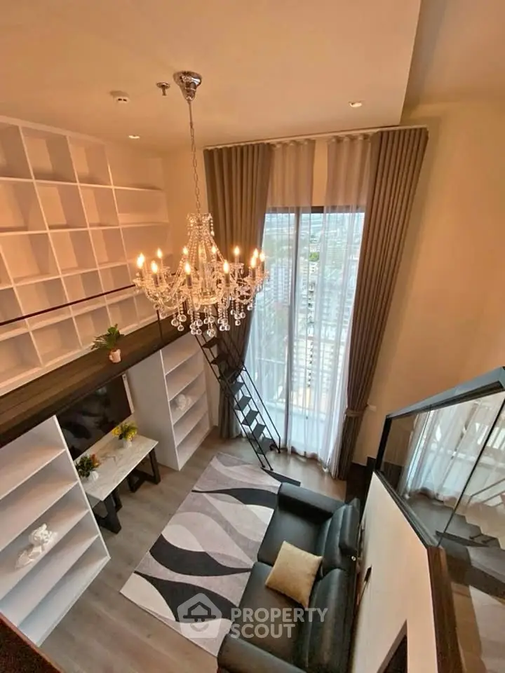 Luxurious loft living room with chandelier and floor-to-ceiling windows