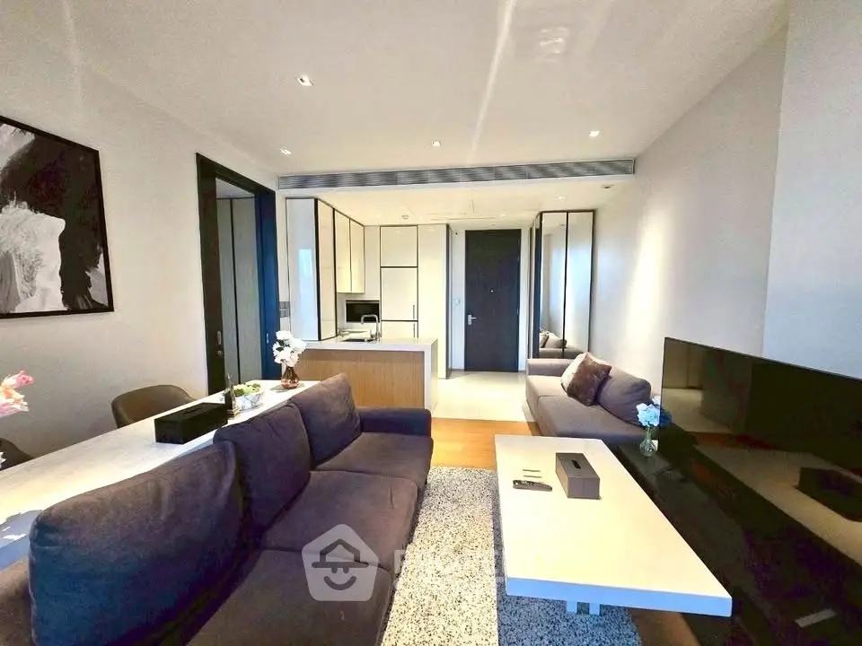 Modern living room with sleek furniture and open kitchen layout, perfect for contemporary living.