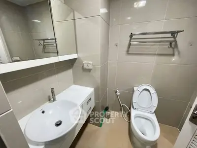 Modern bathroom with sleek fixtures and neutral tiles