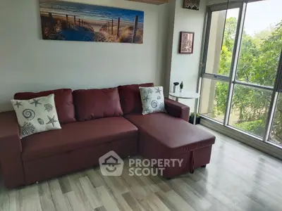 Charming living room with cozy sofa and large window view