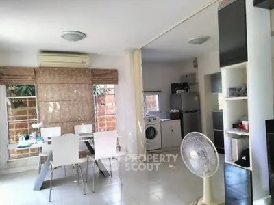 Modern dining area with washing machine and fridge in open layout kitchen