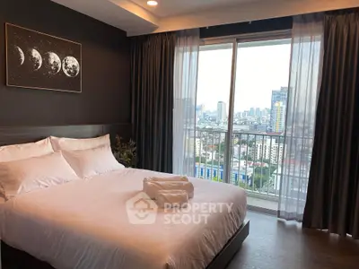 Modern bedroom with city view and elegant decor in high-rise apartment