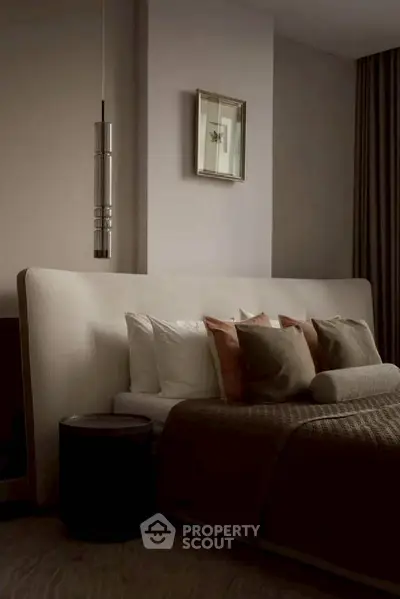 Luxurious bedroom with elegant decor and plush bedding in a modern apartment.