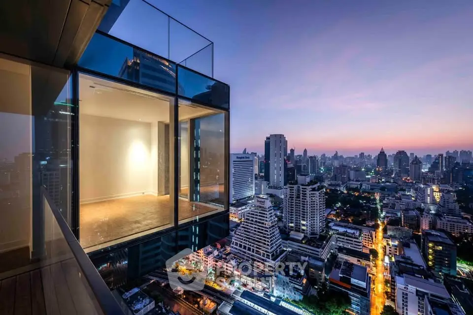 Stunning corner unit with panoramic city view at dusk, featuring floor-to-ceiling windows and modern design.