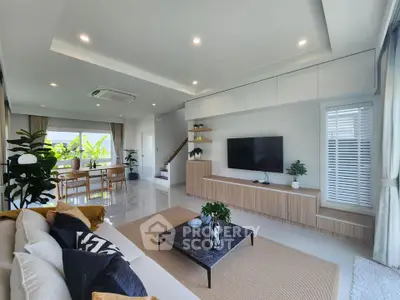 Spacious modern living room with elegant decor and open dining area