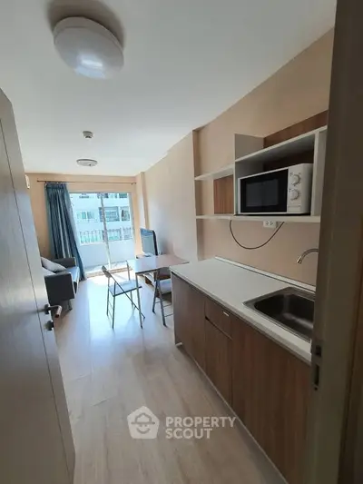 Modern studio apartment with open kitchen and cozy living area