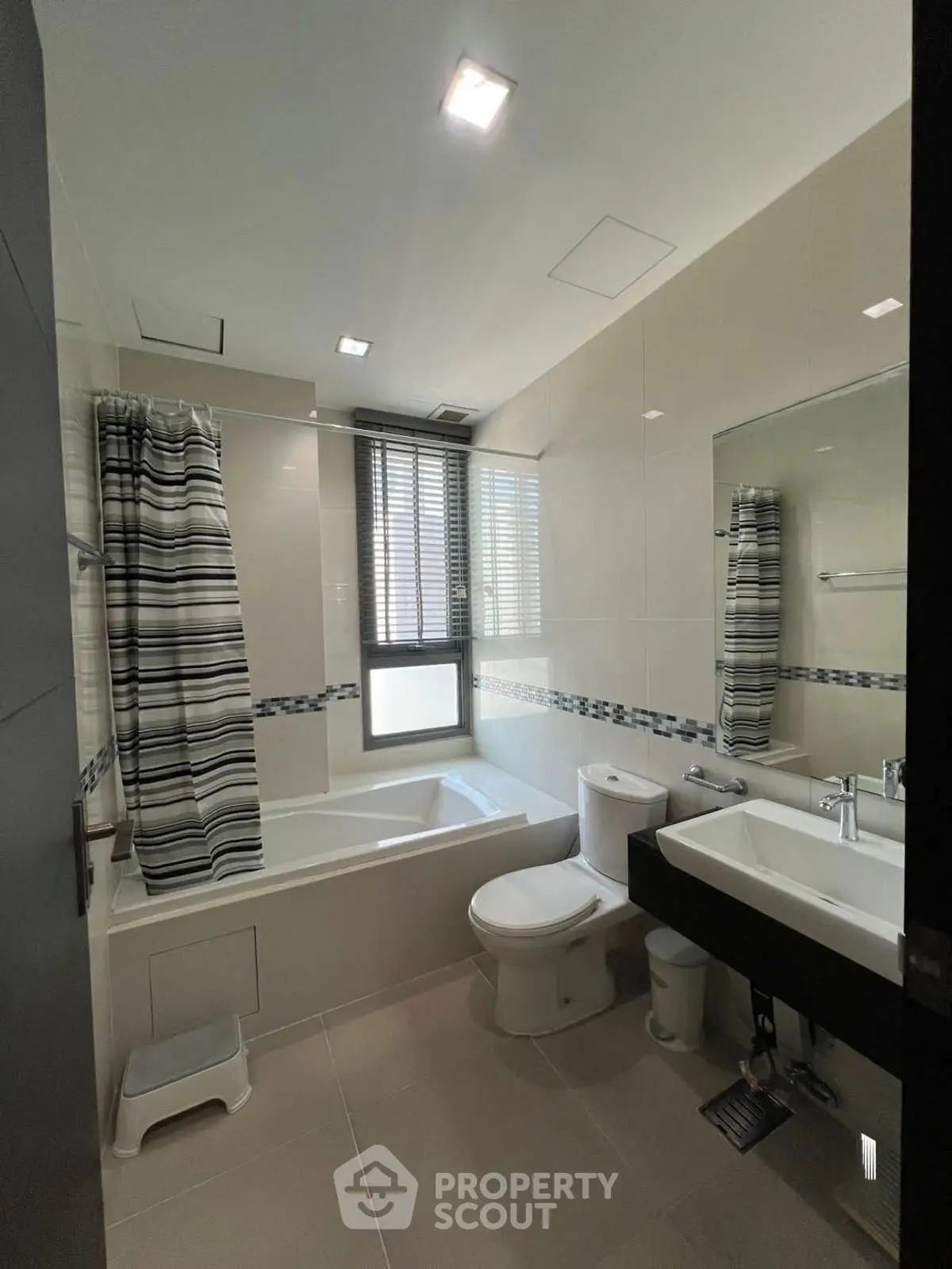 Modern bathroom with bathtub and stylish decor in a contemporary home.