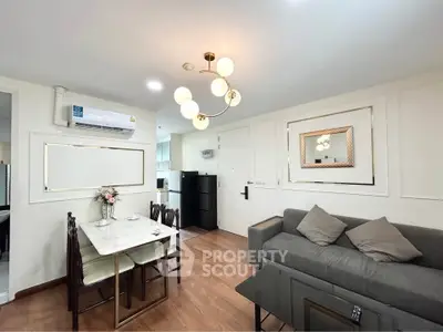 Modern living room with elegant dining area and stylish lighting in a cozy apartment.