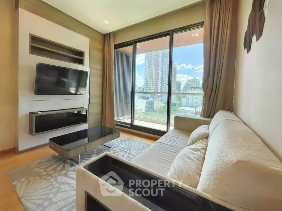 Modern living room with large window and city view, featuring a sleek TV setup and comfortable sofa.