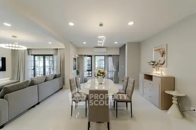 Spacious modern living and dining area with elegant decor and natural light.