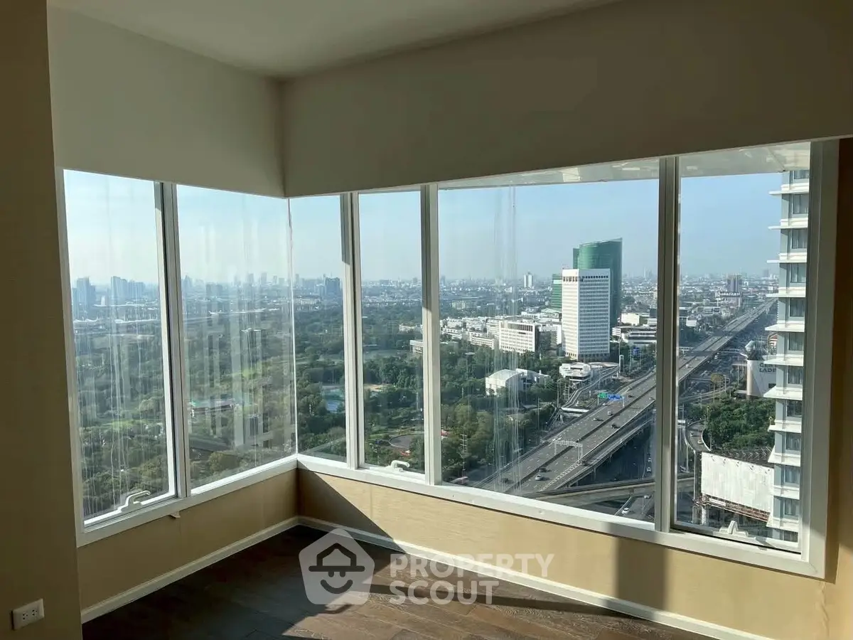 Stunning corner unit with panoramic city views from floor-to-ceiling windows, offering abundant natural light.