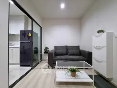 Modern living room with sleek furniture and open kitchen layout