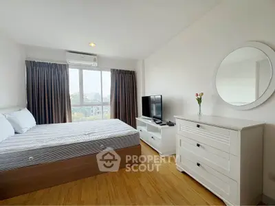 Bright and airy bedroom with modern furnishings and large window view.