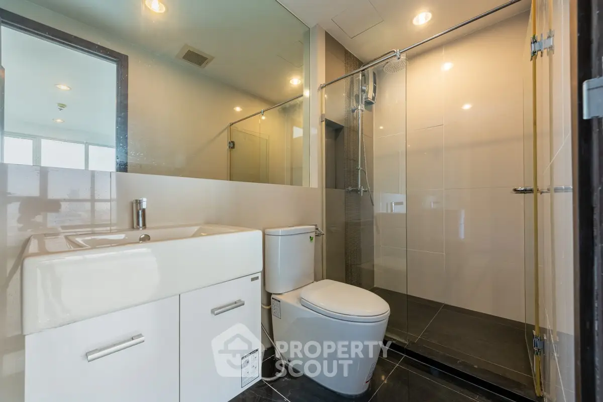 Modern bathroom with glass shower and sleek fixtures
