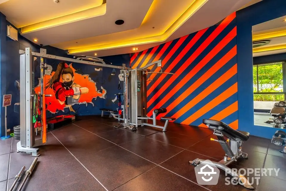 Vibrant gym with modern equipment and colorful wall art, perfect for fitness enthusiasts seeking an energetic workout space.