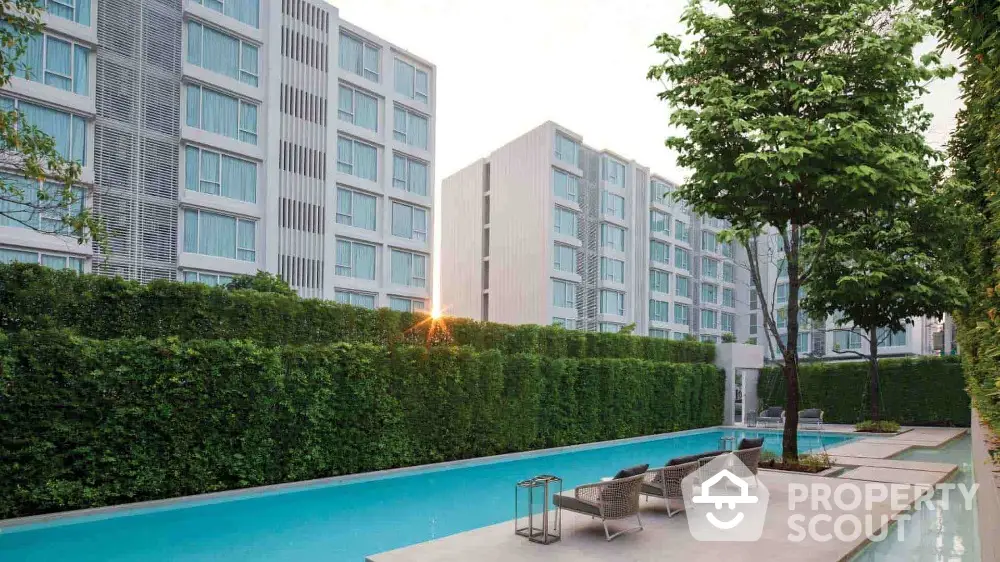 Modern apartment complex with pool and lush greenery, perfect for urban living.