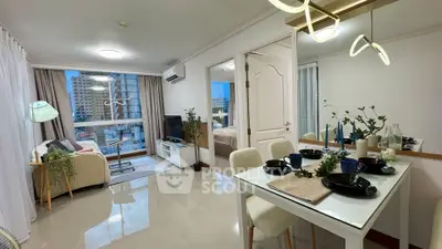Modern open-plan living room and dining area with city view, stylish decor, and natural light.