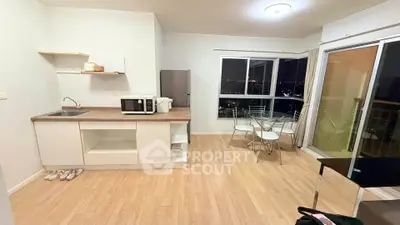 Modern open-layout kitchen and dining area with city view, featuring sleek appliances and wooden flooring.