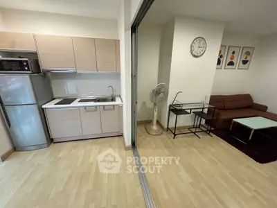 Modern open-plan kitchen and living room with stylish decor and appliances