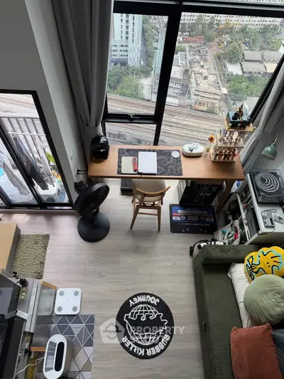 Modern high-rise apartment with floor-to-ceiling windows and stylish interior overlooking cityscape.