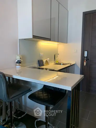 Modern kitchen with sleek design and breakfast bar seating
