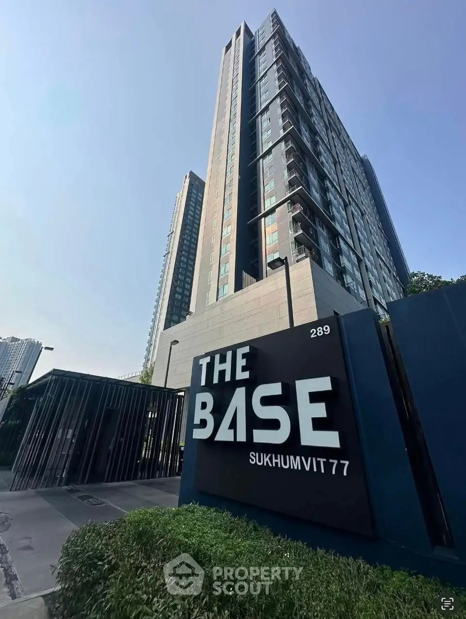 Modern high-rise condominium building with sleek design in Sukhumvit 77.