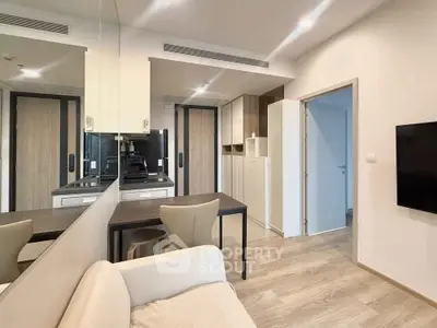 Modern living room with sleek design and open kitchen layout