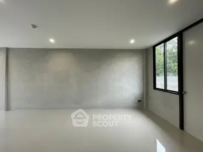 Spacious modern room with large window and minimalist design