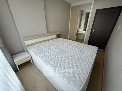 Modern bedroom with minimalist design and comfortable bed in a stylish apartment.
