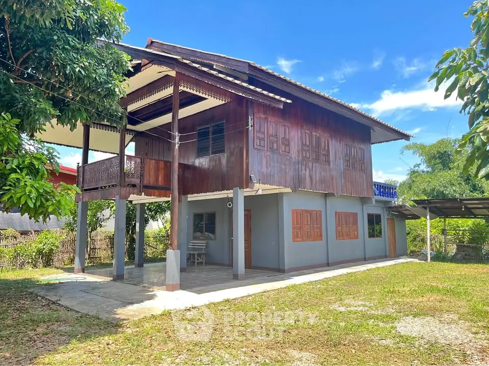 Charming traditional wooden house with spacious yard and lush greenery.