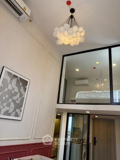 Modern loft apartment with stylish lighting and mezzanine bedroom, featuring a cozy living area and contemporary design.
