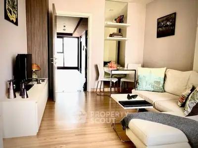 Modern living room with cozy seating and stylish decor in a bright apartment.