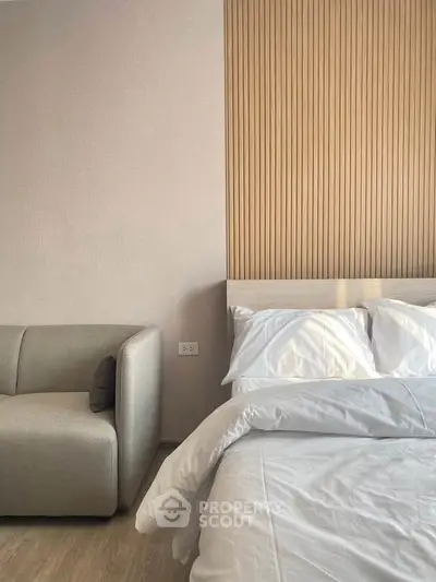 Modern bedroom with cozy bed and stylish wooden accent wall