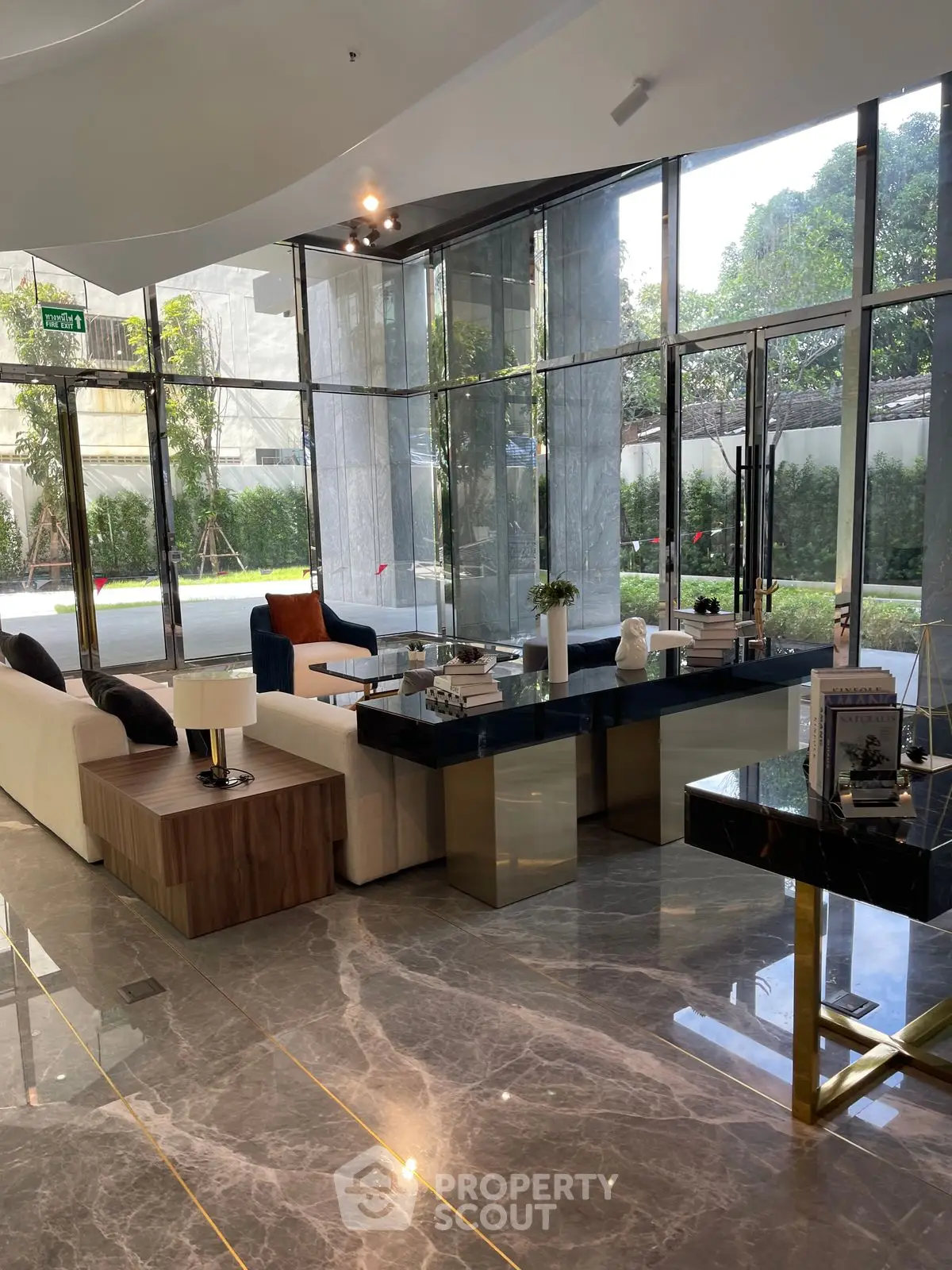 Luxurious modern living room with marble floors and large windows offering garden views.