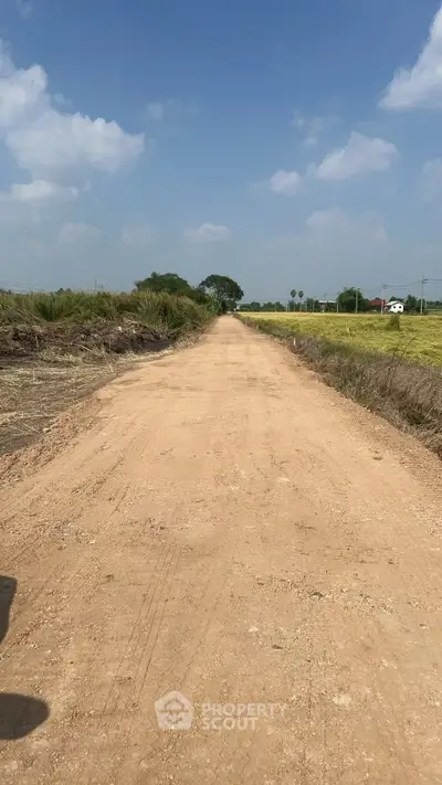 Expansive rural land with clear skies, perfect for development or agriculture.