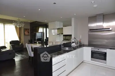 Modern open-layout kitchen with sleek appliances and spacious living area, perfect for contemporary living.
