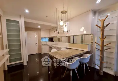 Modern kitchen with sleek design, featuring elegant lighting and stylish dining area.