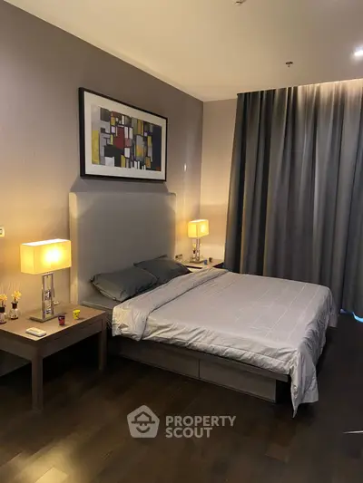 Modern bedroom with stylish decor and ambient lighting, featuring a comfortable bed and elegant furnishings.