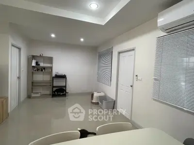 Modern living space with sleek design and air conditioning, featuring a minimalist aesthetic and ample natural light.