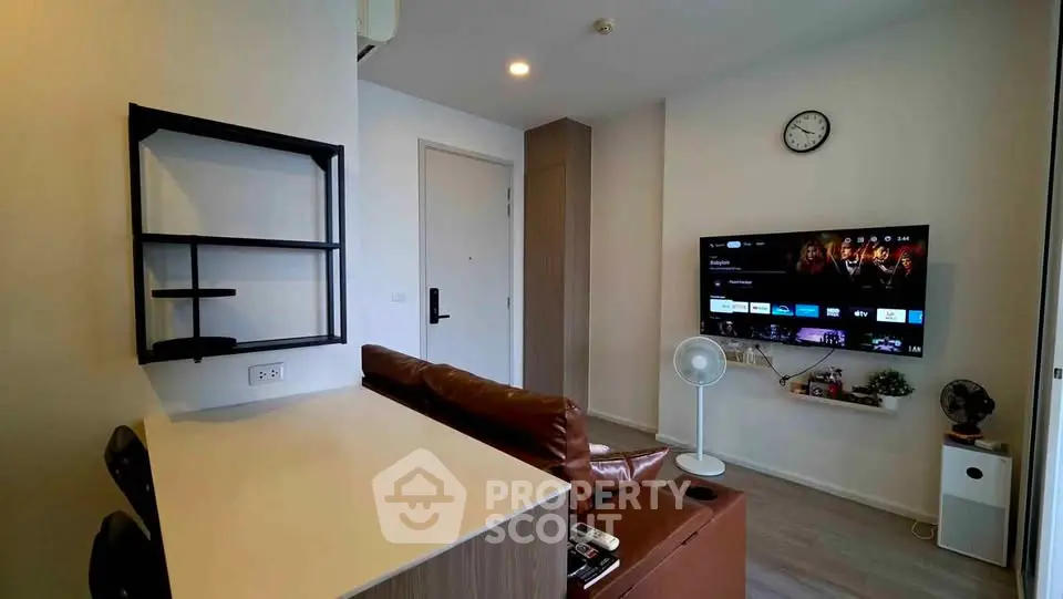 Modern living room with wall-mounted TV and stylish furniture