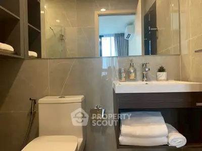 Modern bathroom with sleek fixtures and ample storage space.