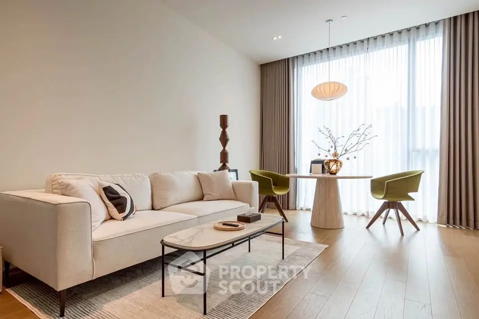 Elegant living room with modern furniture and large window, perfect for relaxation and entertaining.